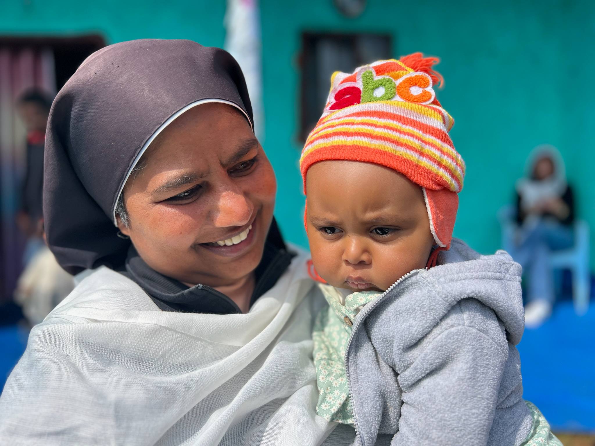 A Sister with a young child at Getche Health Centre